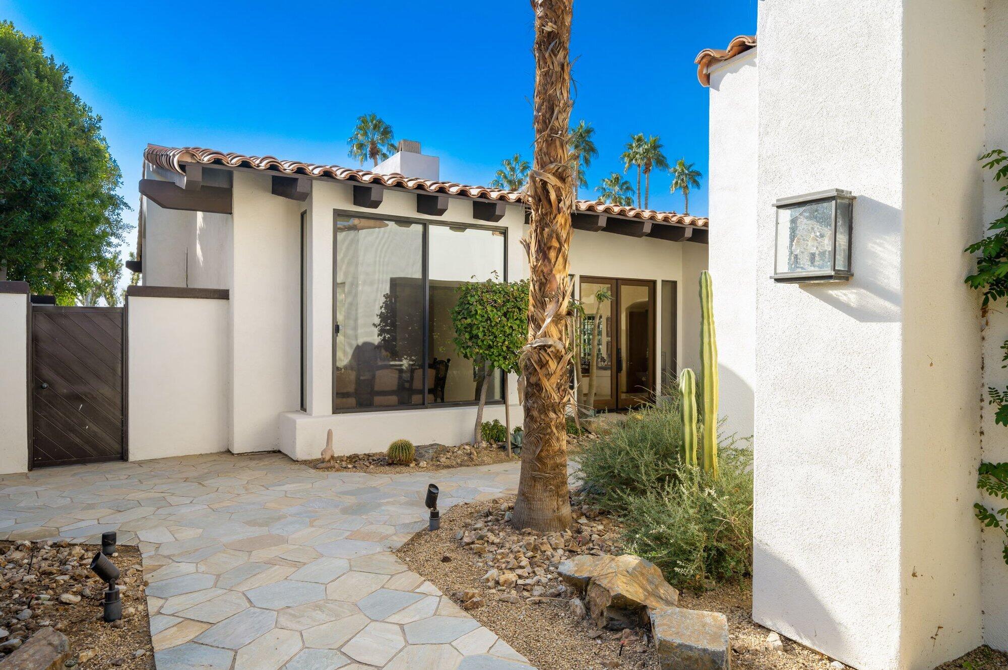 55880 Pinehurst La Quinta, CA 92253 - Photo 14 of 54 a front view of a house with a yard