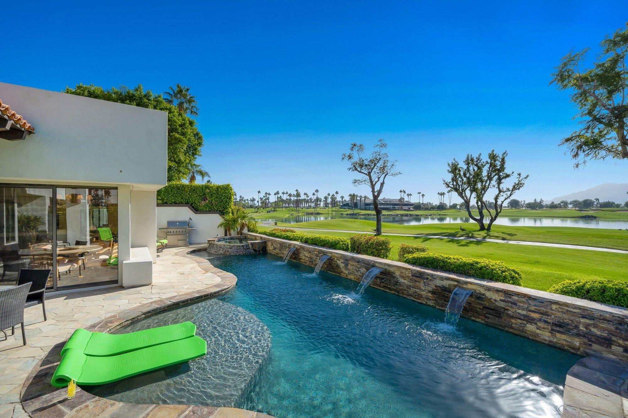 55880 Pinehurst La Quinta, CA 92253 - Photo 2 of 54 a view of a swimming pool and lounge chairs in back yard of the house