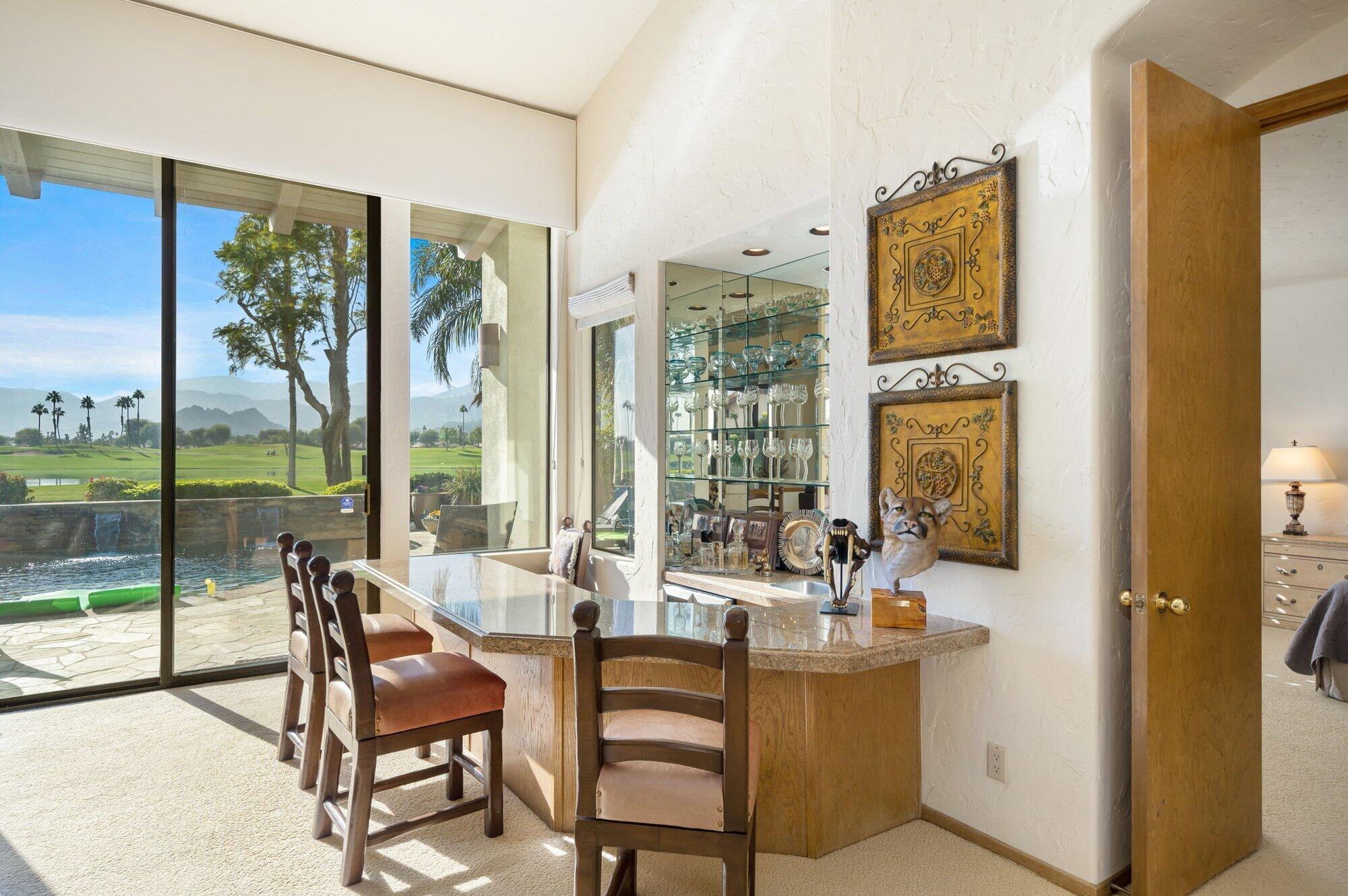 55880 Pinehurst La Quinta, CA 92253 - Photo 23 of 54 a living room with furniture and a floor to ceiling window
