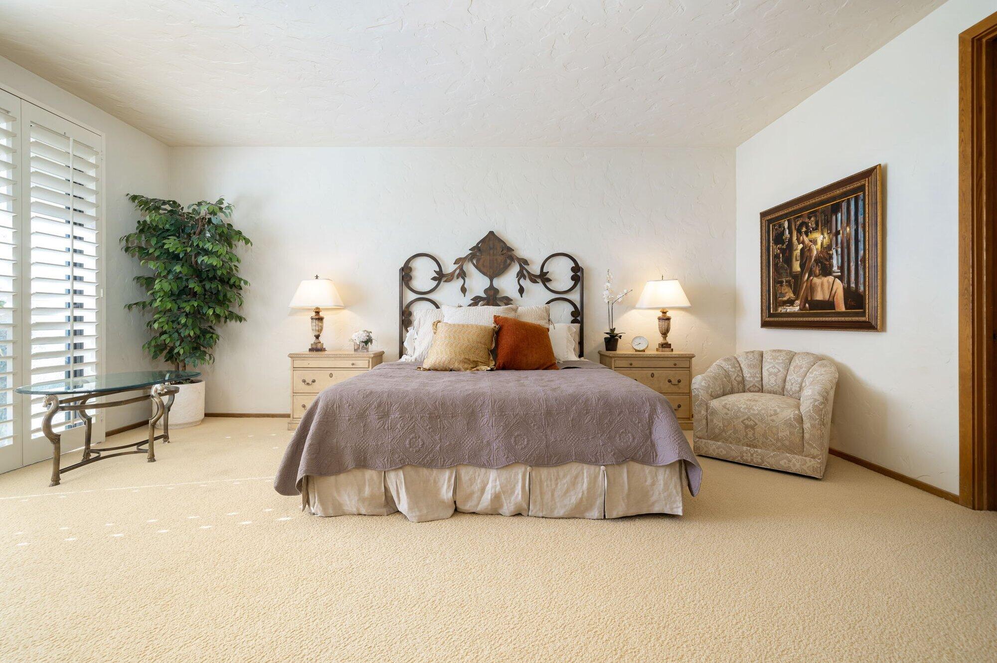 55880 Pinehurst La Quinta, CA 92253 - Photo 35 of 54 a spacious bedroom with a bed and a couch