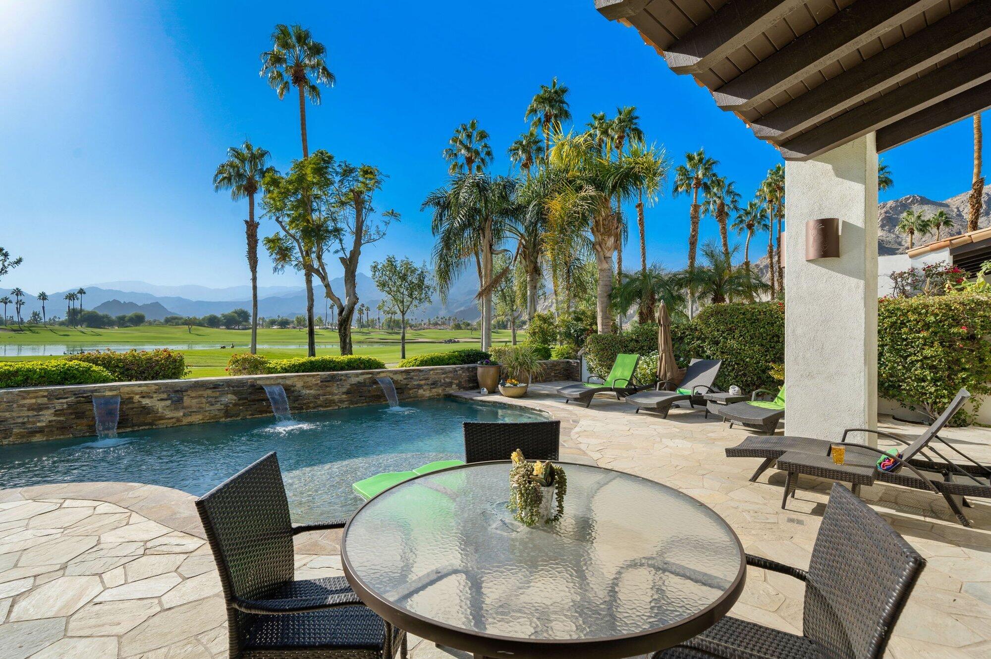 55880 Pinehurst La Quinta, CA 92253 - Photo 4 of 54 a view of a swimming pool with a table and chairs