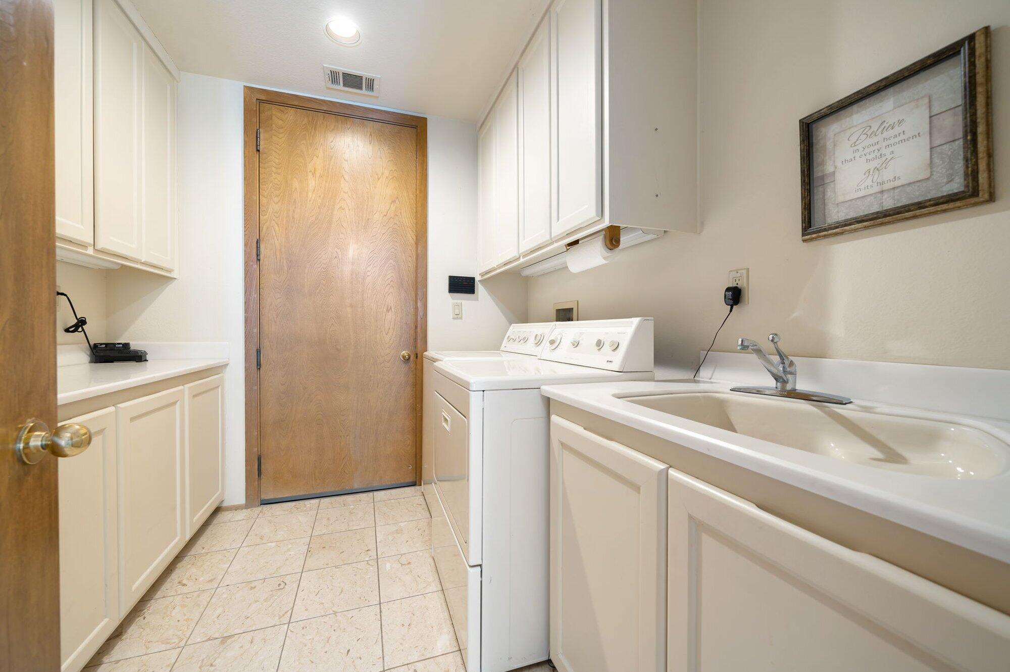55880 Pinehurst La Quinta, CA 92253 - Photo 45 of 54 a utility room with cabinets washer and dryer