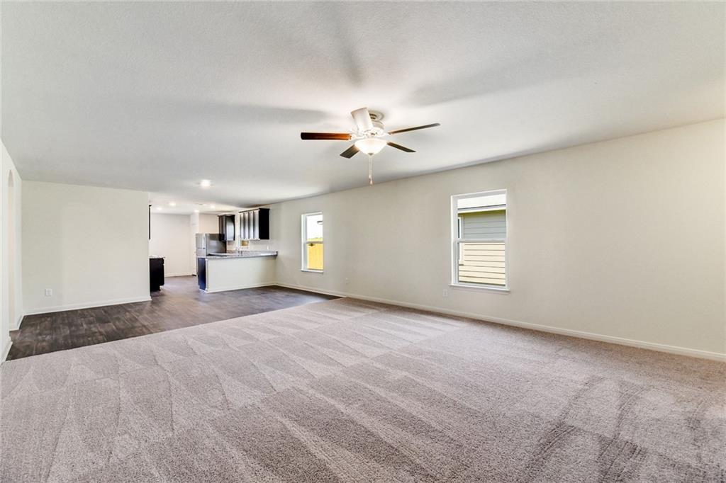 14008 Prospector Way Elgin, TX 78621 - Photo 2 of 7 a view of a livingroom with a ceiling fan and window