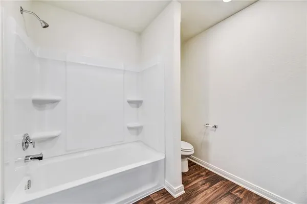 a bathroom with a bathtub and toilet