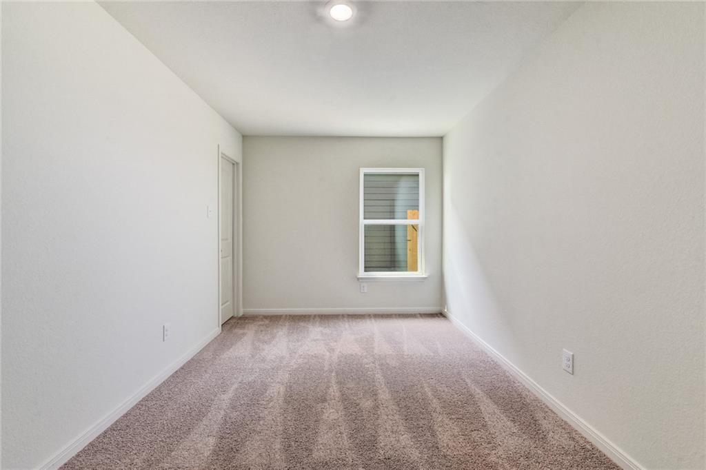 14008 Prospector Way Elgin, TX 78621 - Photo 6 of 7 an empty room with windows