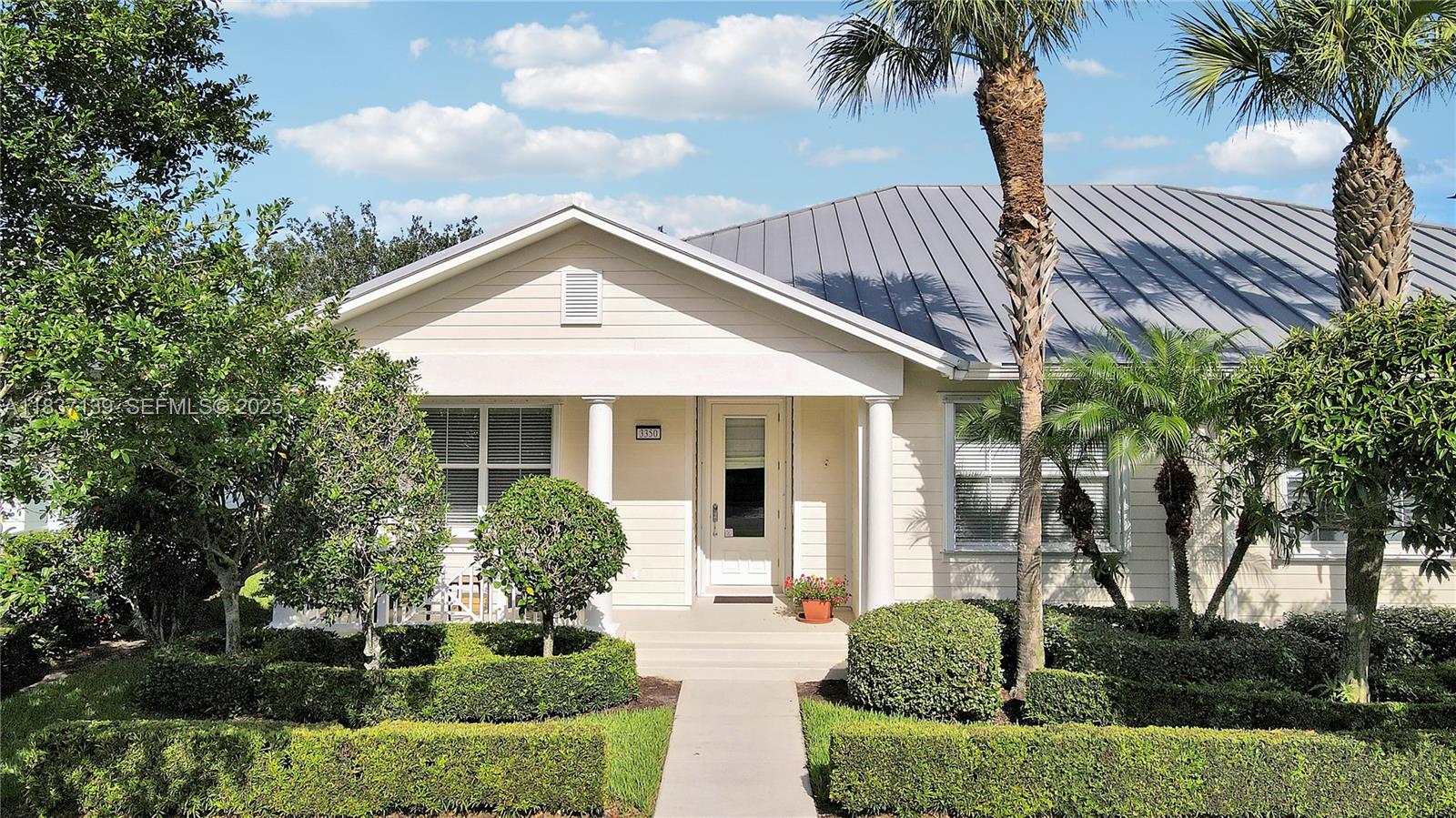a front view of a house with a garden