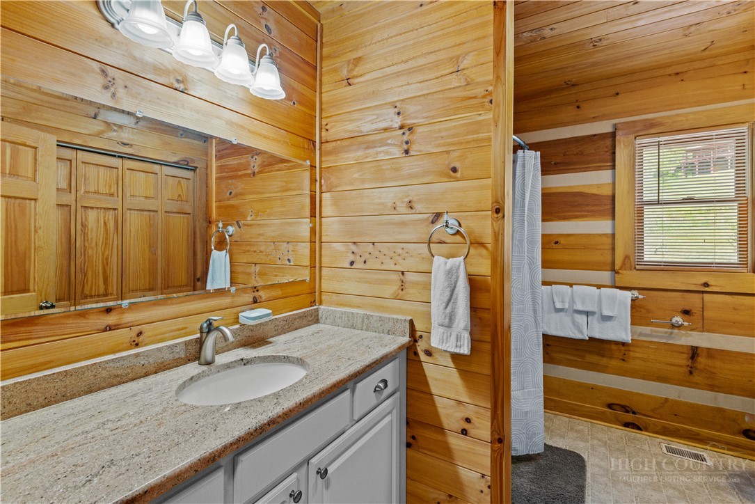 339 Welcome Way Boone, NC 28607 - Photo 11 of 20 a bathroom with a granite countertop sink and a large mirror