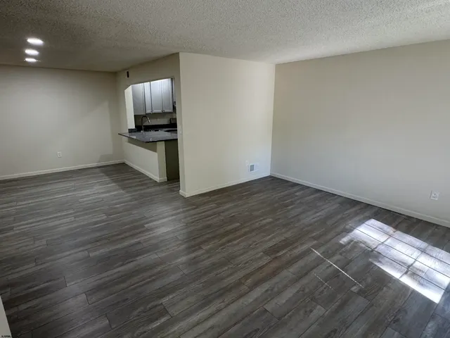 a view of kitchen view wooden floor and electronic appliances
