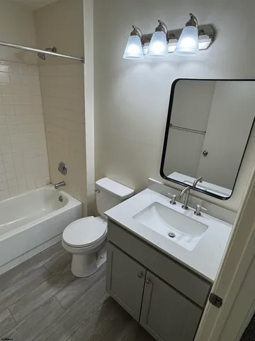 a bathroom with a sink toilet a mirror and vanity