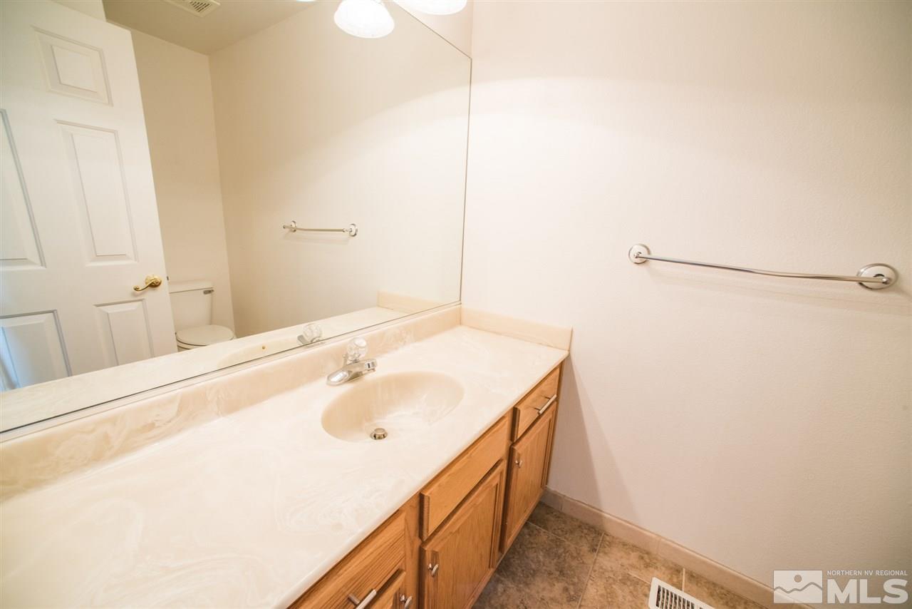 1980 Honey Ridge Drive Reno, NV 89511 - Photo 18 of 31 a bathroom with a sink and a mirror