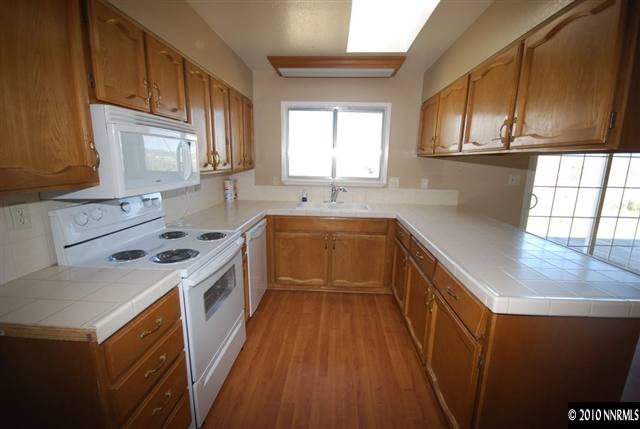 10505 Wells Fargo Road Reno, NV 89508 - Photo 4 of 9 a kitchen with a sink stove and cabinets
