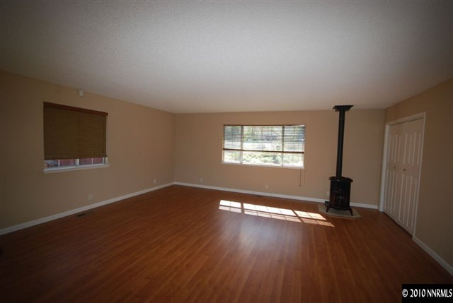 10505 Wells Fargo Road Reno, NV 89508 - Photo 5 of 9 a view of empty room with wooden floor and fan