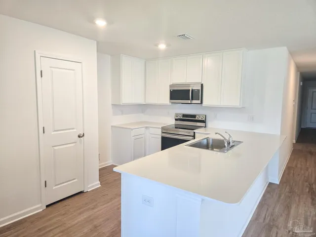 a kitchen with a sink a stove and refrigerator