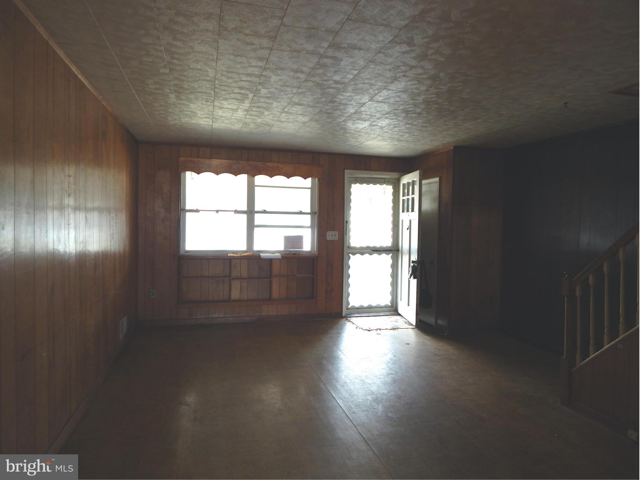 1918 Jasmine Road Dundalk, MD 21222 - Photo 3 of 12 an empty room with wooden floor and windows