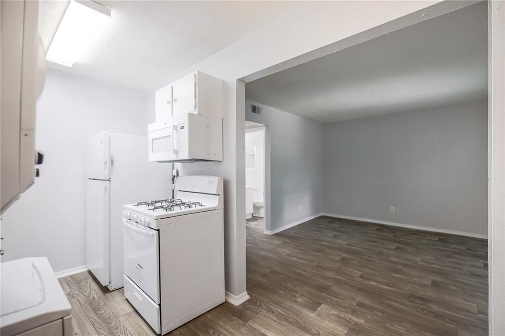 2401 Manor Road, Unit 221 Austin, TX 78722 - Photo 5 of 21 A well-appointed kitchen with essential appliances flows into a versatile living space.