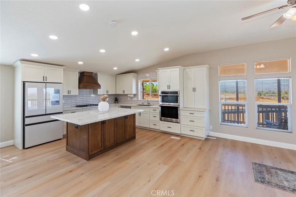 19310 Ann Way Perris, CA 92570 - Photo 11 of 75 a large kitchen with stainless steel appliances granite countertop a large counter top and a wooden floors