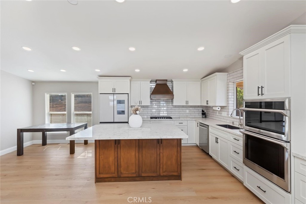 19310 Ann Way Perris, CA 92570 - Photo 15 of 75 a large kitchen with stainless steel appliances granite countertop a large counter top and a stove