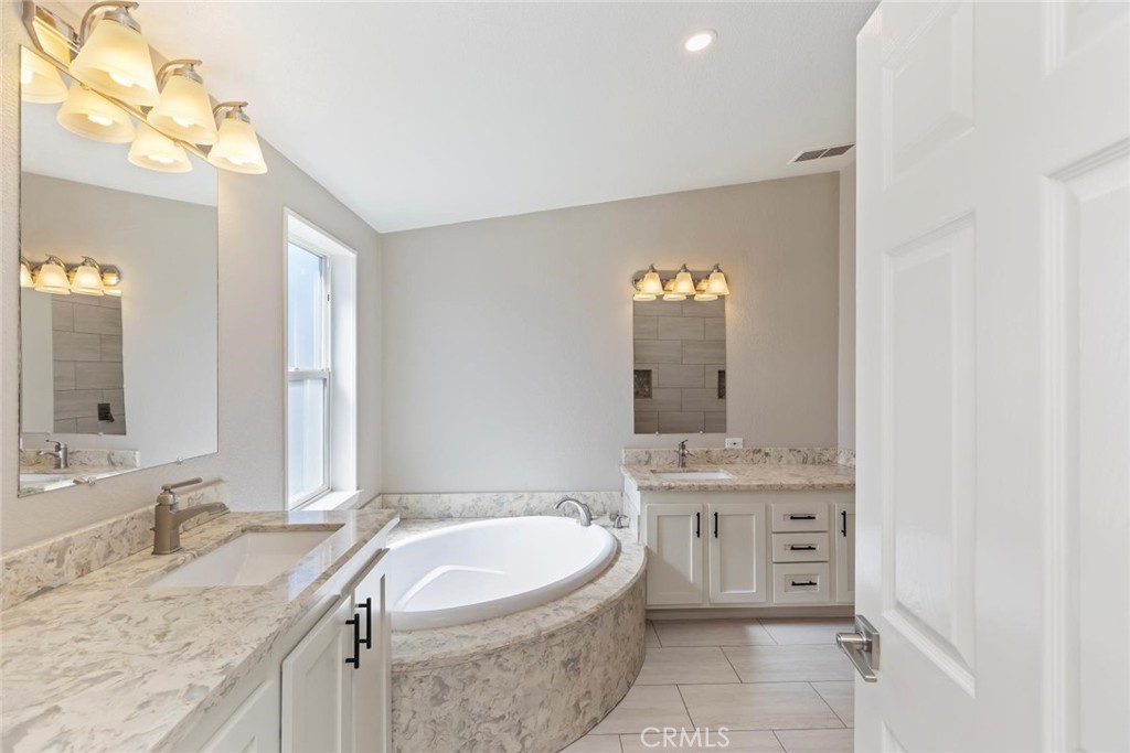 19310 Ann Way Perris, CA 92570 - Photo 29 of 75 a bathroom with a granite countertop sink mirror and bathtub