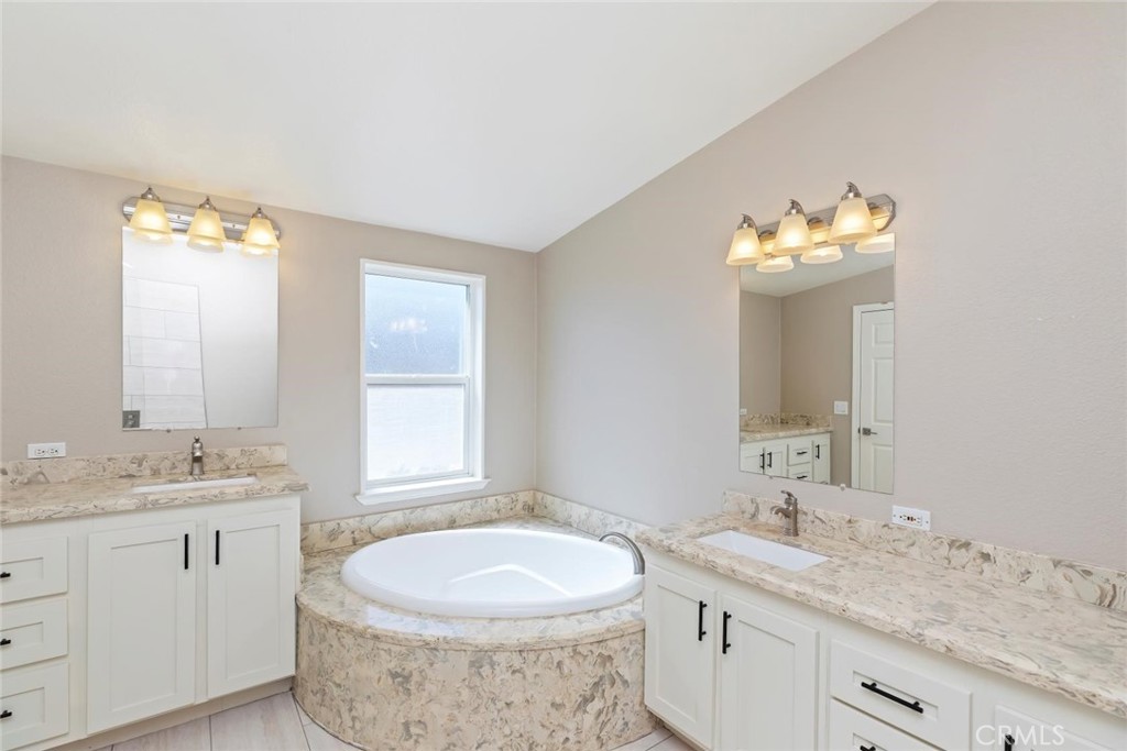 19310 Ann Way Perris, CA 92570 - Photo 30 of 75 a bathroom with a granite countertop sink and a mirror