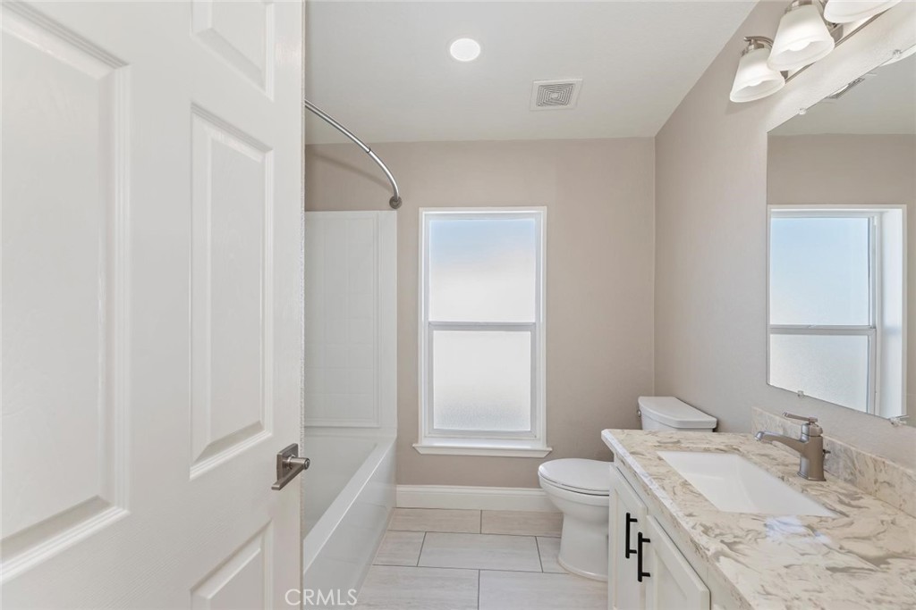 19310 Ann Way Perris, CA 92570 - Photo 32 of 75 a bathroom with a granite countertop sink toilet and shower