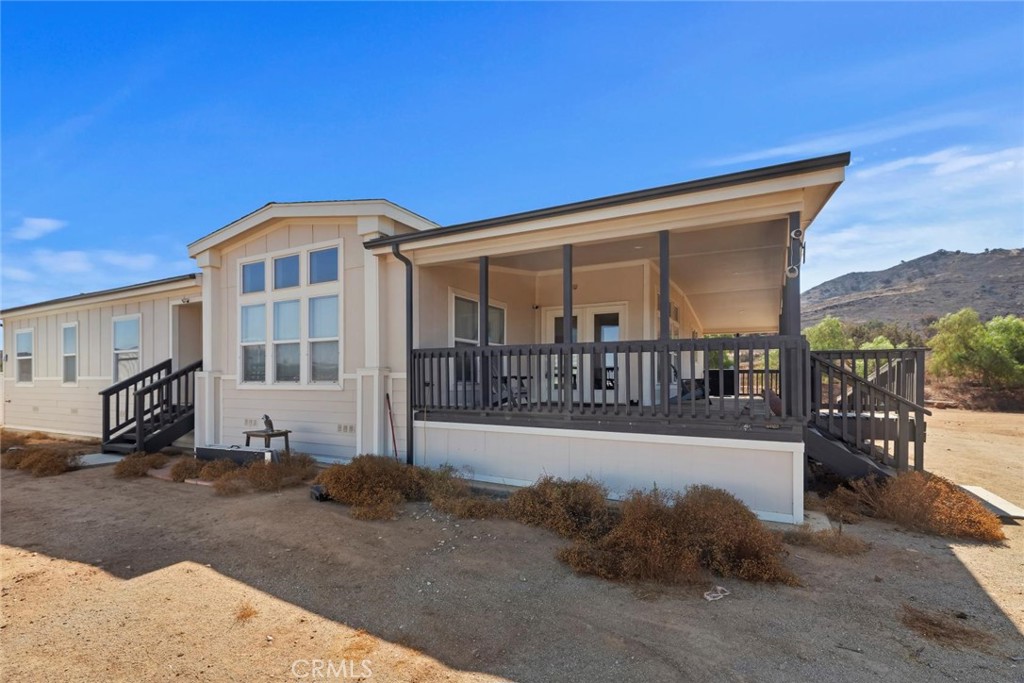 19310 Ann Way Perris, CA 92570 - Photo 42 of 75 a view of a house with a floor to ceiling window and a small yard