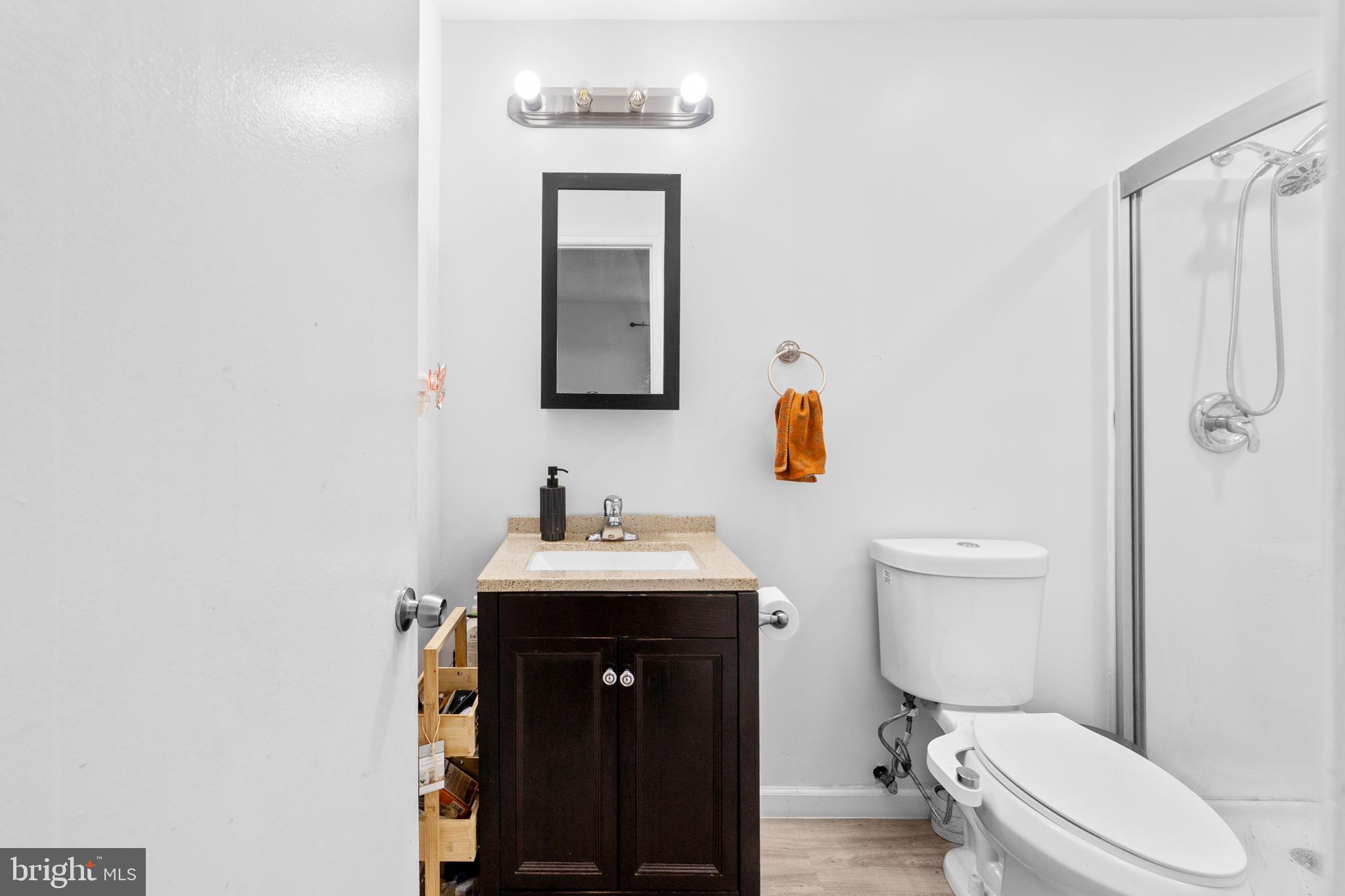 25C Pitman Road, Unit B Monroe Township, NJ 08831 - Photo 22 of 29 a bathroom with a toilet a sink and mirror