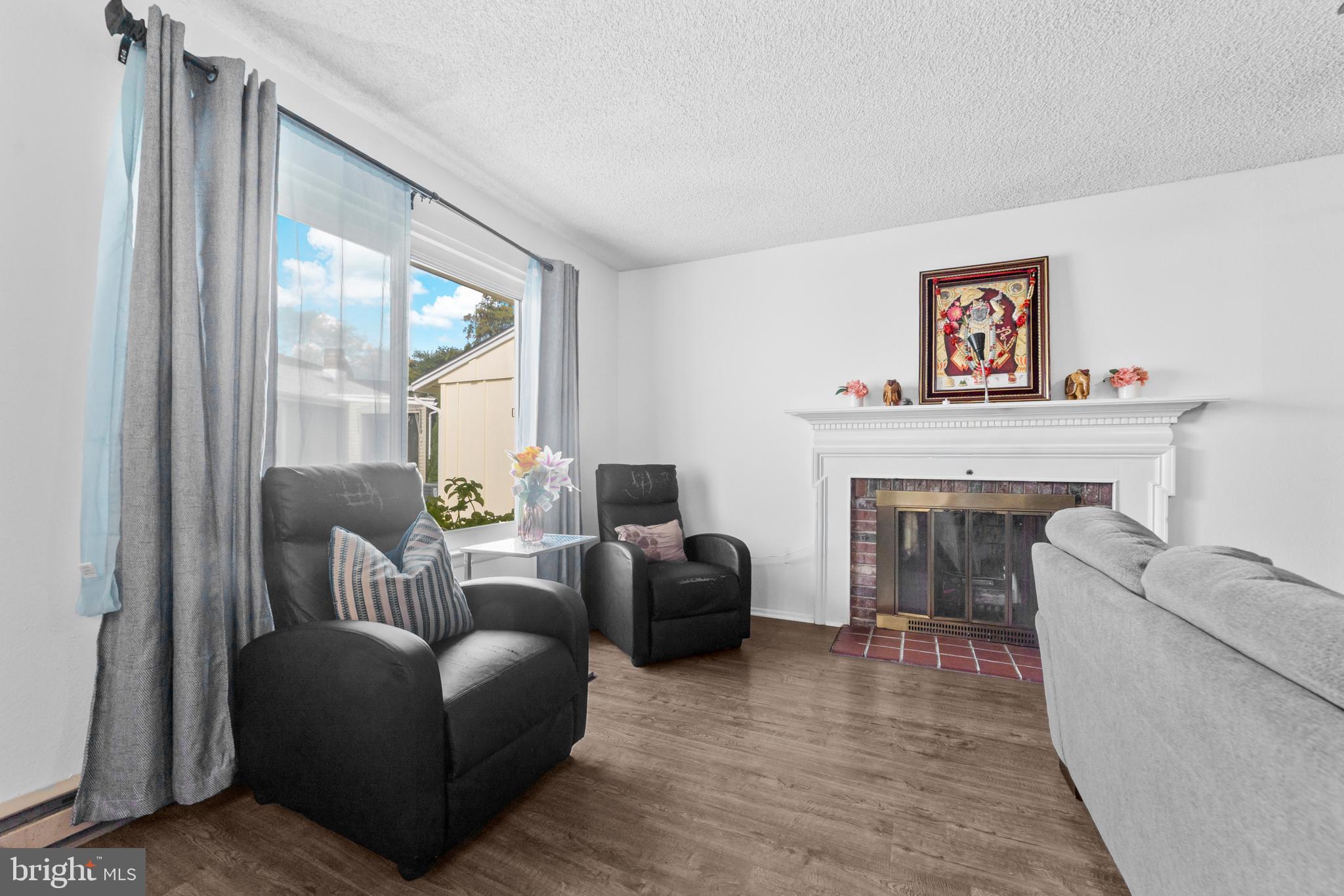25C Pitman Road, Unit B Monroe Township, NJ 08831 - Photo 7 of 29 a living room with furniture and a fireplace