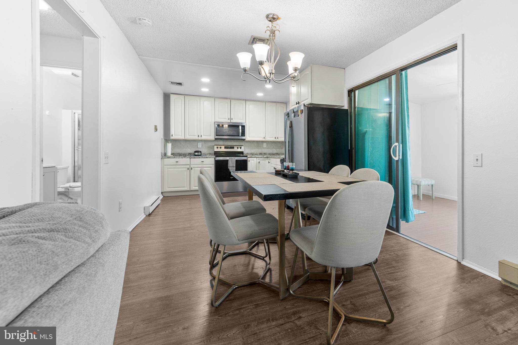 25C Pitman Road, Unit B Monroe Township, NJ 08831 - Photo 9 of 29 a view of a dining room with furniture and wooden floor