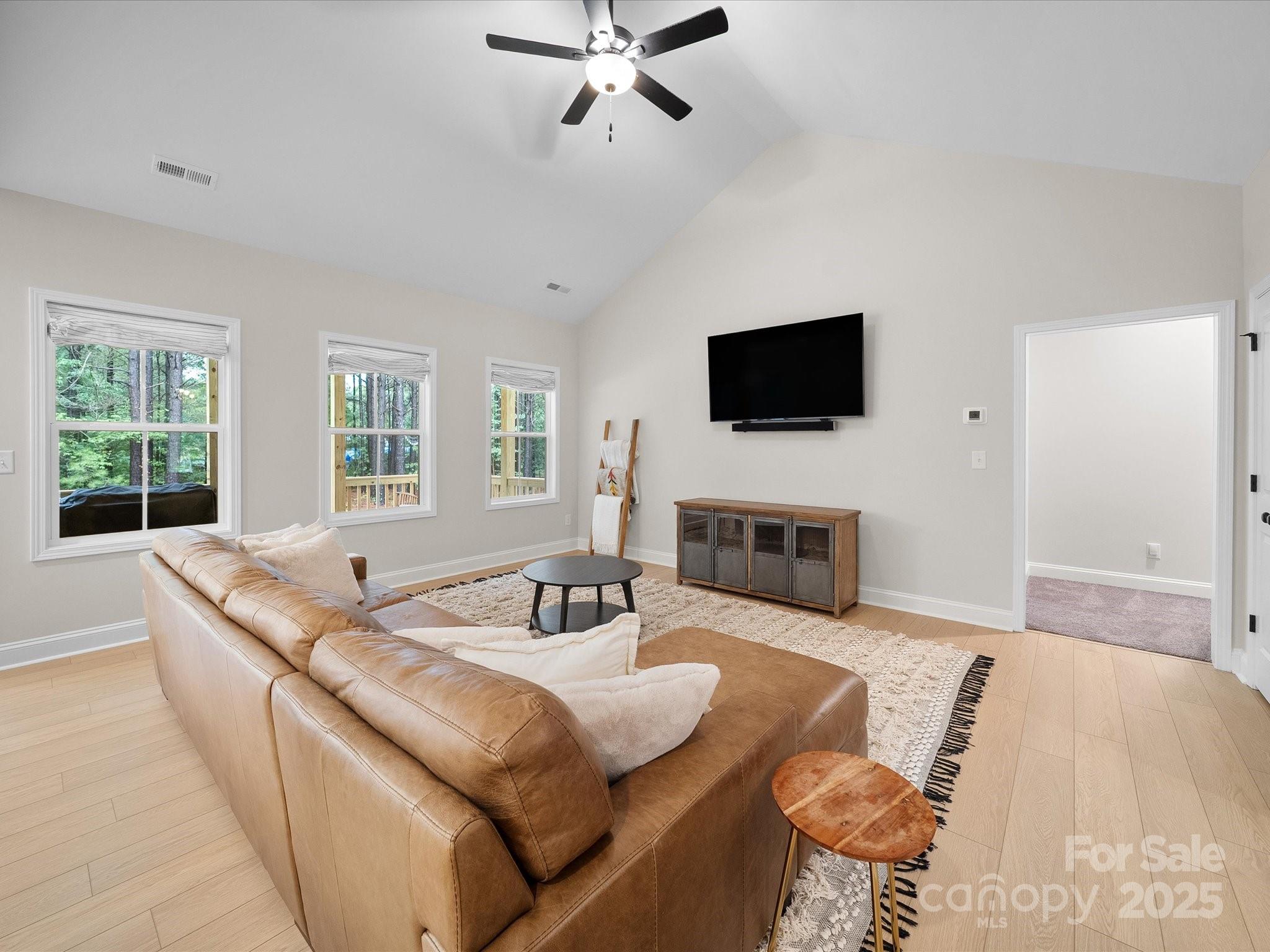 5408 Unionville Road Monroe, NC 28110 - Photo 14 of 31 a living room with furniture a fireplace and a flat screen tv