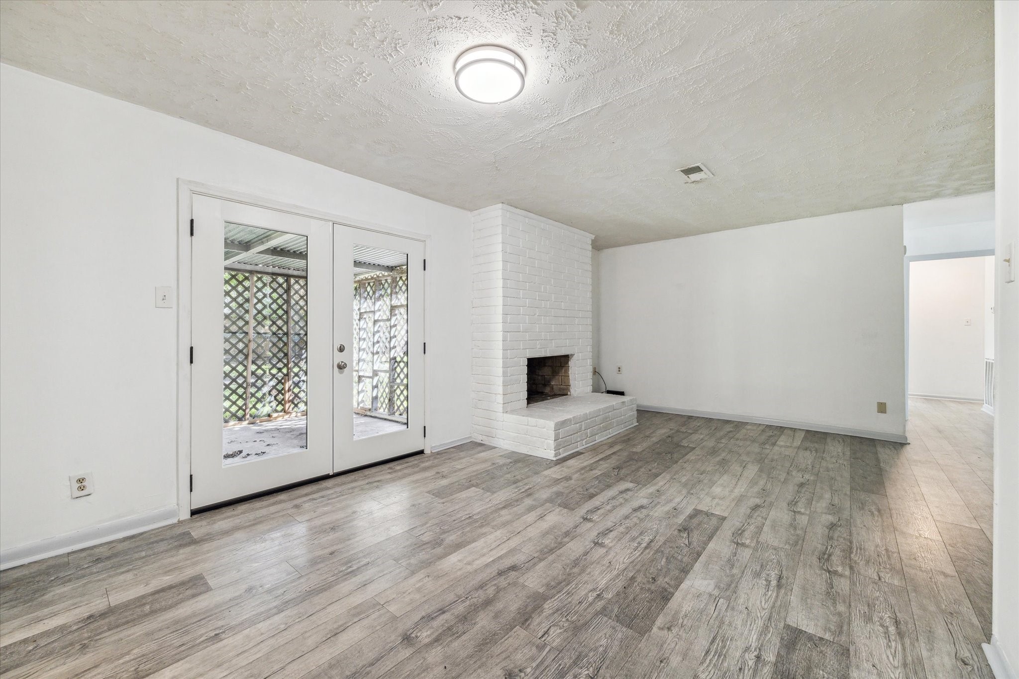 8814 Jason Street Houston, TX 77074 - Photo 3 of 14 an empty room with wooden floor and windows