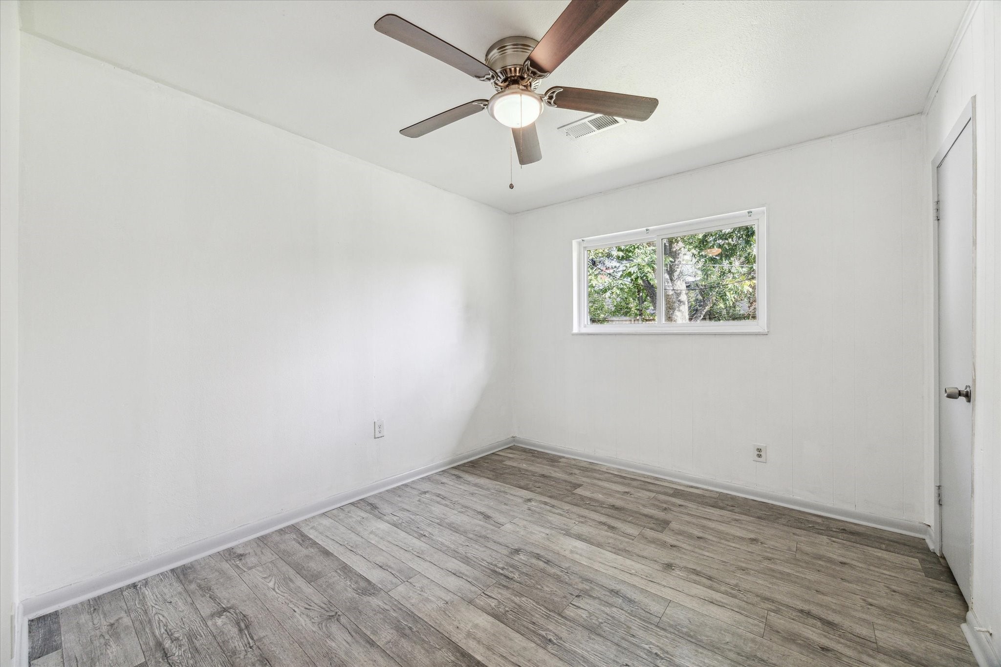 8814 Jason Street Houston, TX 77074 - Photo 6 of 14 an empty room with wooden floor and ceiling fan