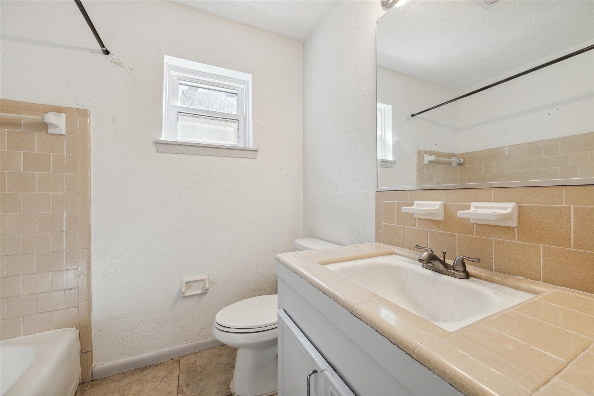 8814 Jason Street Houston, TX 77074 - Photo 9 of 14 a bathroom with a sink a toilet and shower