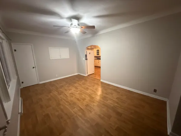 wooden floor in an empty room with a window