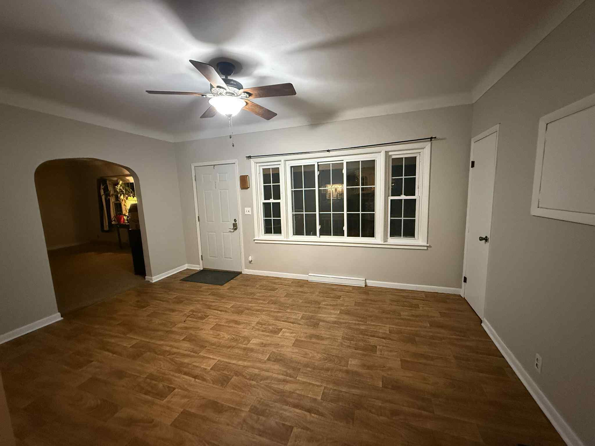 301 Hoffman Street Crown Point, IN 46307 - Photo 7 of 15 a view of an empty room with window and wooden floor