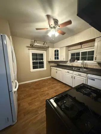 a view of a livingroom with a ceiling fan and window
