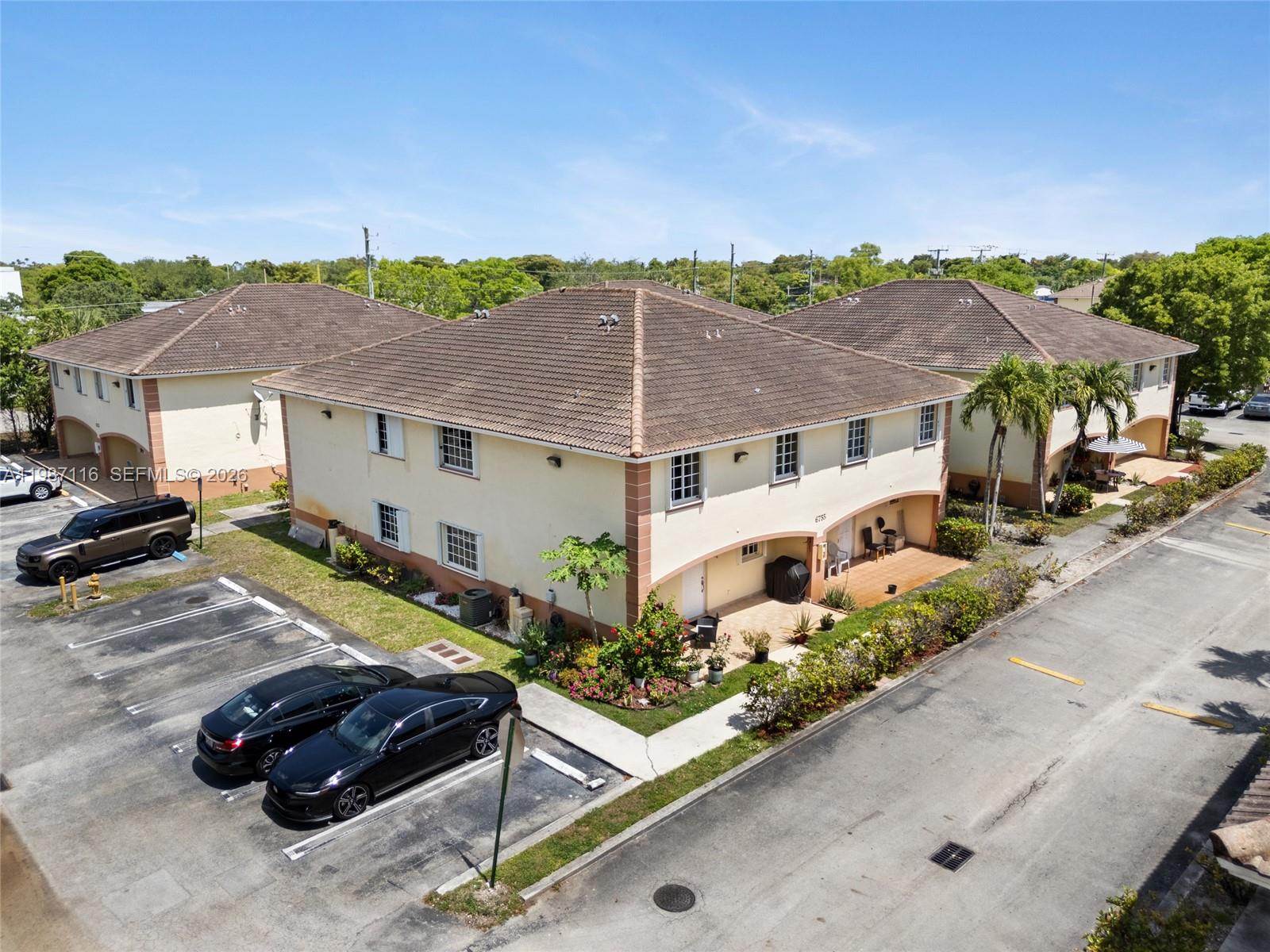 6755 Northwest 182nd Street, Unit 104 Hialeah, FL 33015 - Photo 3 of 33 a view of a house with a yard and patio