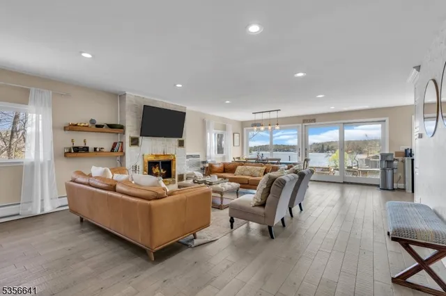 a living room with furniture flat screen tv and a fireplace