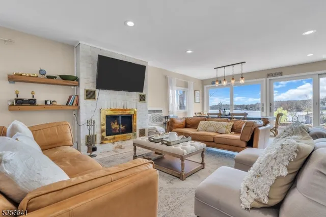 a living room with furniture fireplace and a flat screen tv
