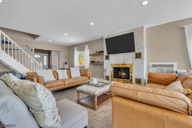 a living room with furniture fireplace and flat screen tv