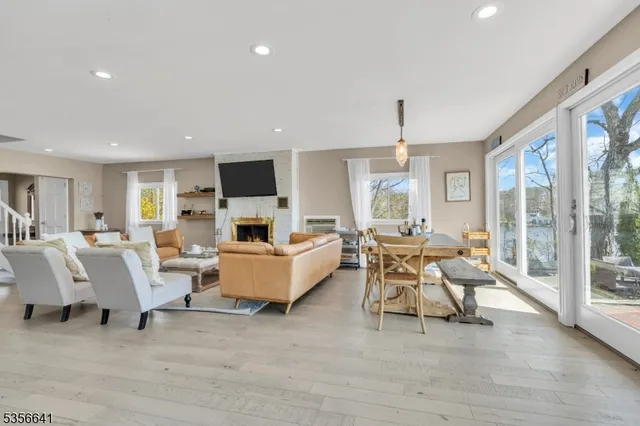 a living room with fireplace furniture and a large window