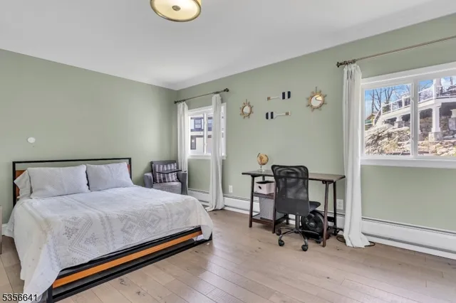 a bedroom with a bed and a chair in it