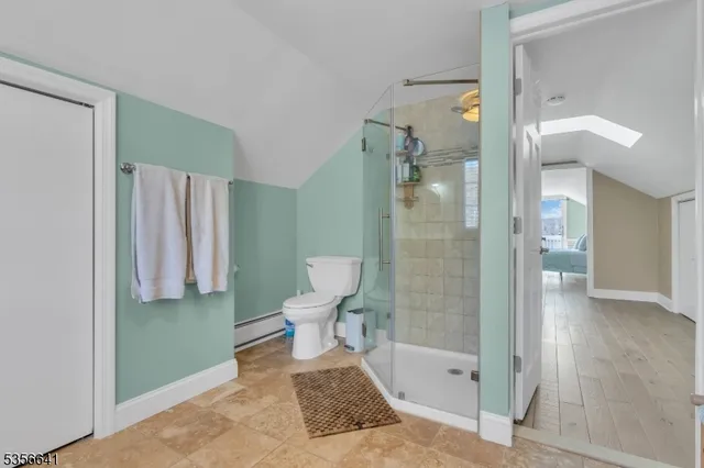 a bathroom with a toilet and a shower