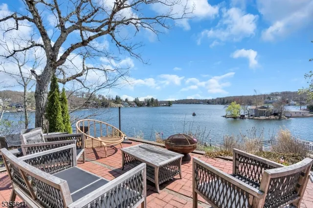 a view of a roof deck with couches and wooden floor