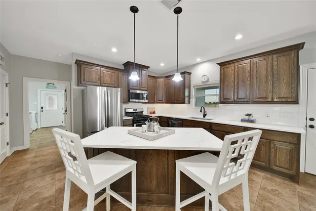 a kitchen with a sink and chandelier