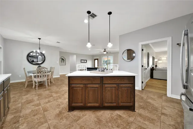 a view of a dining room kitchen and a chandelier