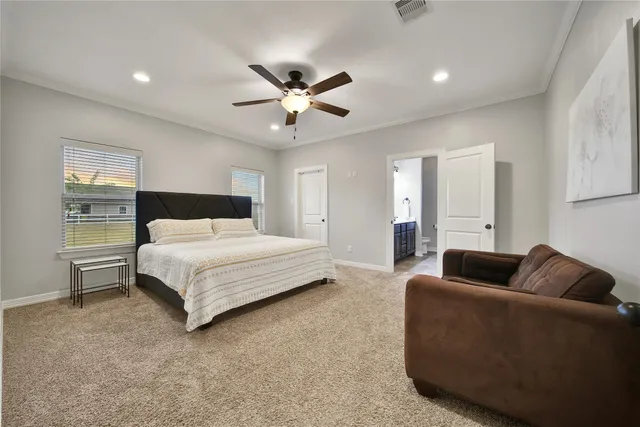 a bedroom with a large bed and a chandelier