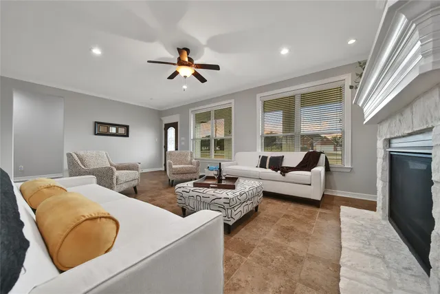 a living room with couches and kitchen view with wooden floor