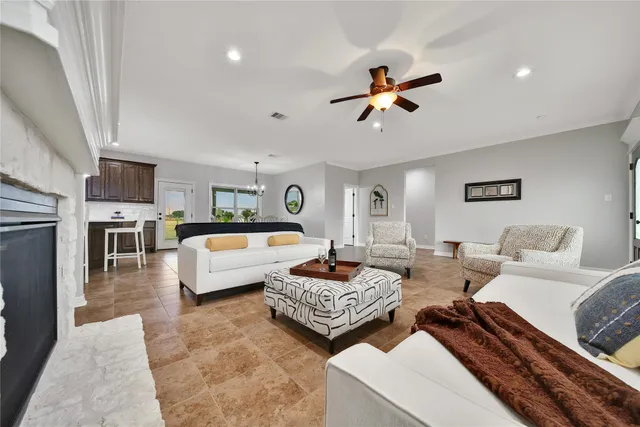 a kitchen with granite countertop a refrigerator and a sink