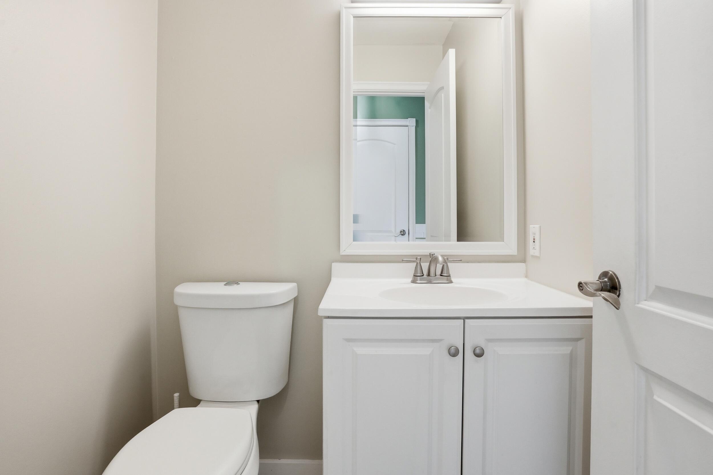 12358 Tippecanoe Place Crown Point, IN 46307 - Photo 14 of 30 a bathroom with a toilet sink and mirror