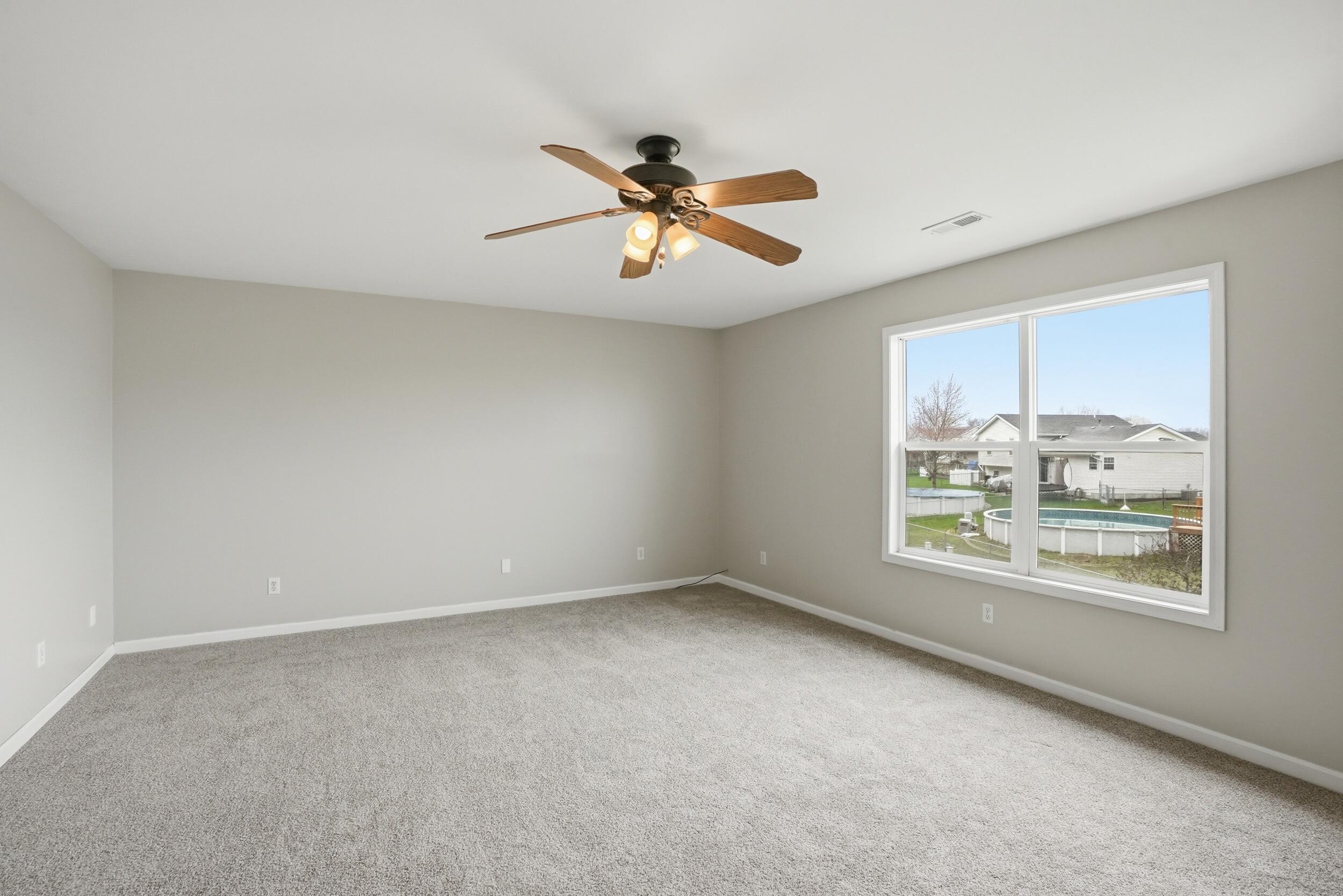 12358 Tippecanoe Place Crown Point, IN 46307 - Photo 15 of 30 an empty room with windows and fan
